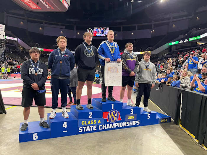 Omaha North's Tyson Terry stands atop the state podium last month after completing his third straight unbeaten championship season. Terry is one of more than 30 heavyweights on the SBLive list of the best in Nebraska. Photo by OmahaPubSchool on X.
